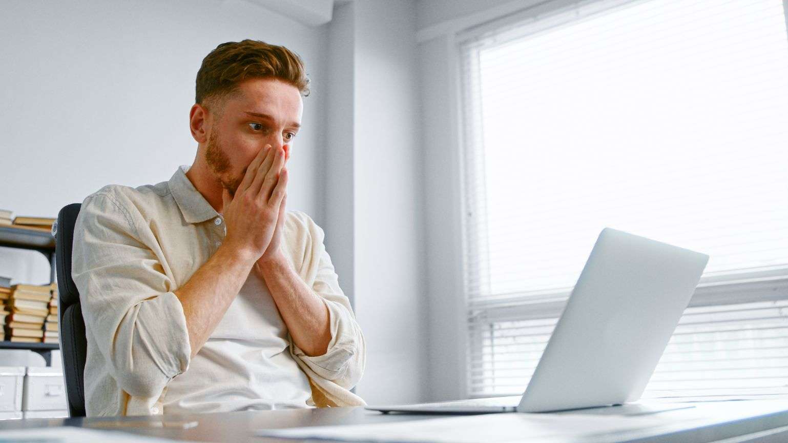 man-looks-laptop